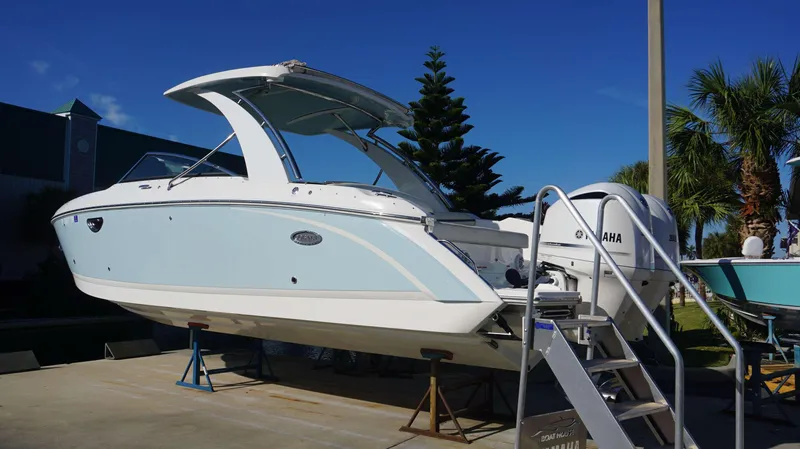 Slide: The Image of 2020 Cobalt 30 SC boat with Yamaha engine on display outdoors. - 2