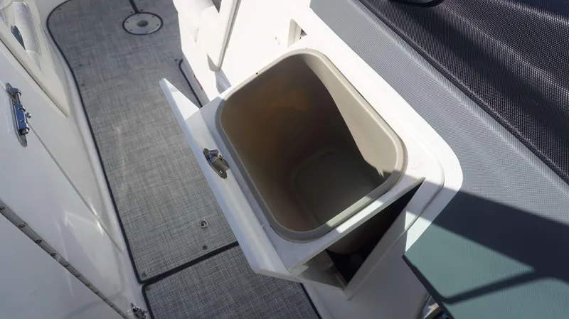 Slide: The Image of Open storage compartment on 2020 Cobalt 30 SC boat interior. - 21