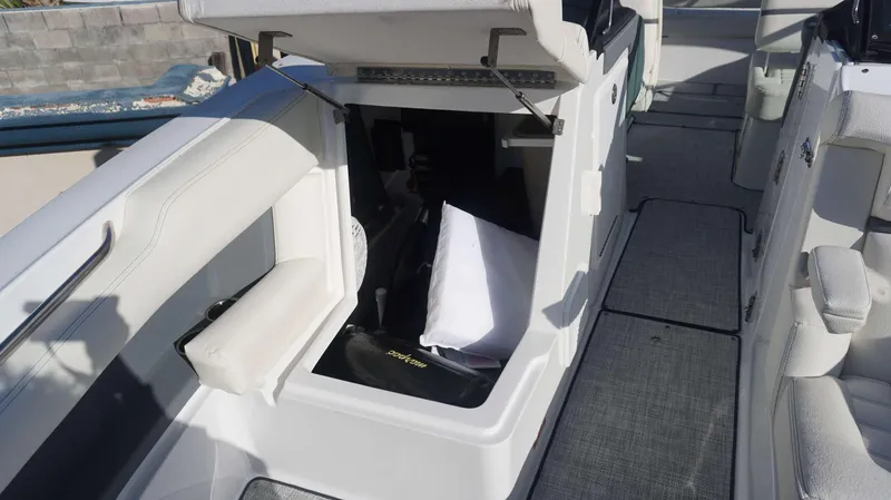 Slide: The Image of 2020 Cobalt 30 SC boat interior with open storage compartment. - 7