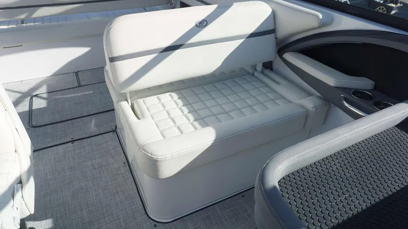 Slide: The Image of 2020 Cobalt 30 SC boat interior with white cushioned seating and modern design. - 9