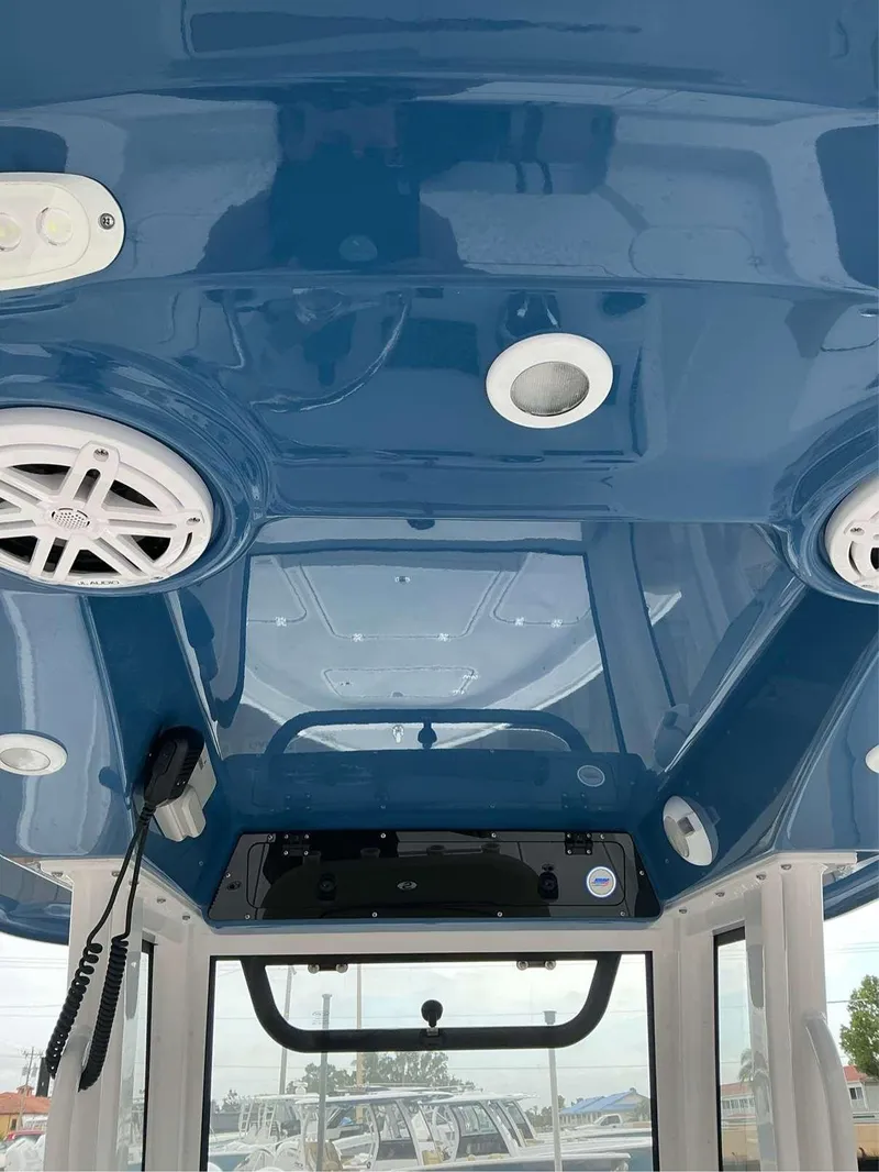 Slide: The Image of Interior view of 2025 Sportsman 227 MASTERS boat, featuring blue ceiling and audio system. - 10