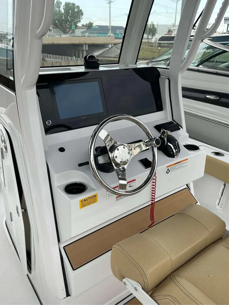 Slide: The Image of 2025 Sportsman 227 MASTERS boat console with steering wheel and navigation display. - 11