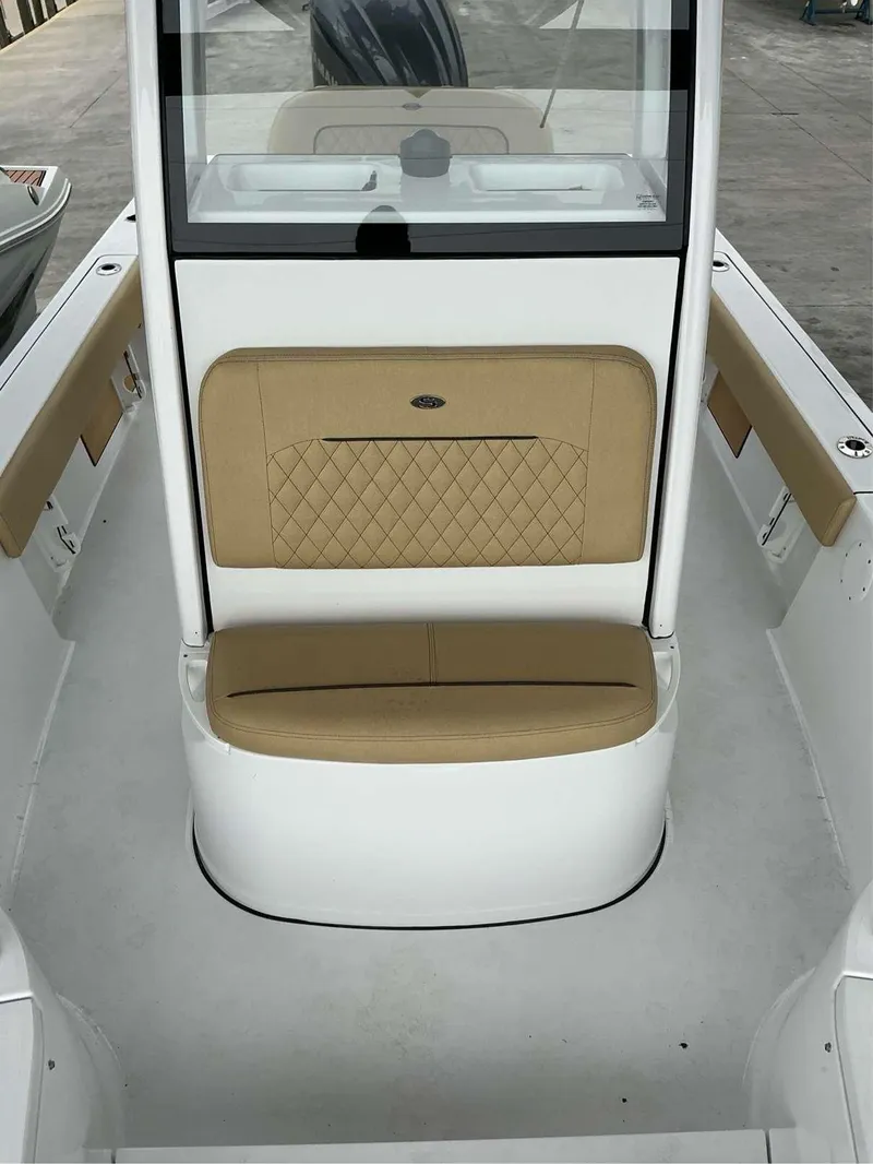 Slide: The Image of 2025 Sportsman 227 MASTERS boat interior with tan cushioned seating. - 3