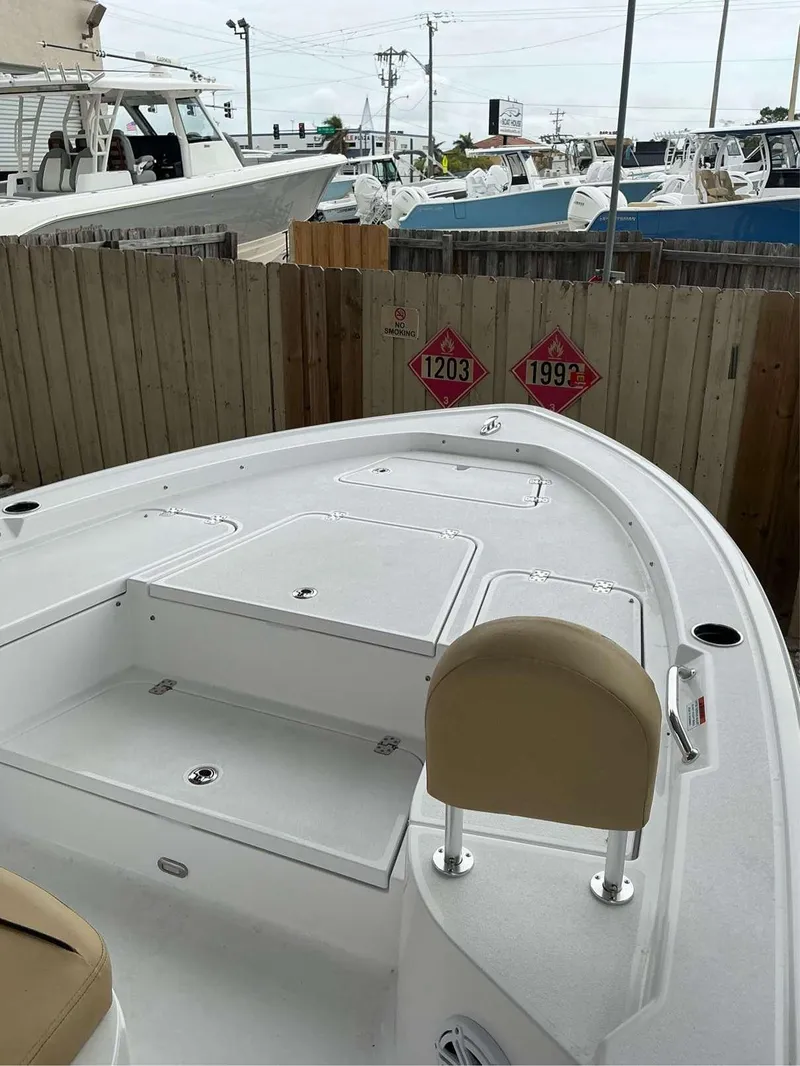 Slide: The Image of 2025 Sportsman 227 MASTERS boat deck with seating, docked near wooden fence. - 4