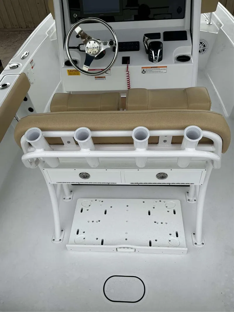 Slide: The Image of 2025 Sportsman 227 MASTERS boat interior with steering wheel and rod holders. - 8