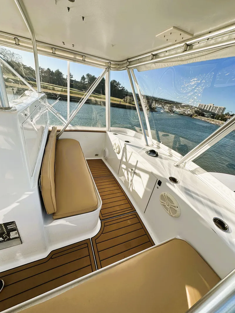 Slide: The Image of Interior of 2000 Blackwell 47 Custom Carolina Sportfish boat with tan seating and wood flooring. - 11