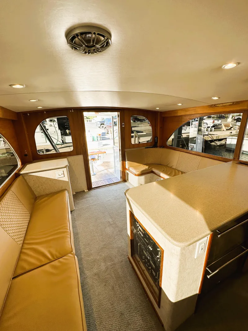 Slide: The Image of Interior of 2000 Blackwell 47 Custom Carolina Sportfish, featuring spacious seating and elegant design. - 16