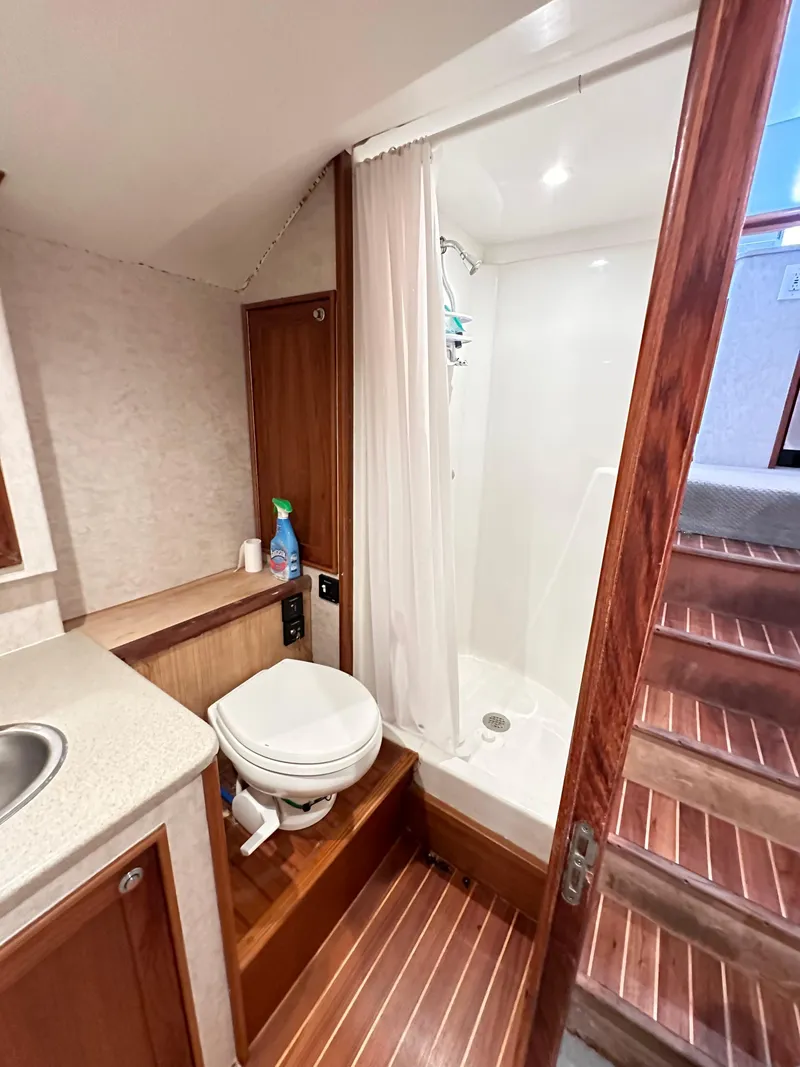 Slide: The Image of 2000 Blackwell 47 Custom Carolina Sportfish bathroom with shower and wooden flooring. - 21