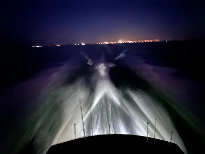 Slide: The Image of Blackwell 47 Custom Carolina Sportfish cruising at night, city lights in the distance. - 22