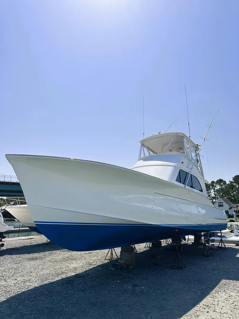 Slide: The Image of 2000 Blackwell 47 Custom Carolina Sportfish boat on land under clear sky. - 4