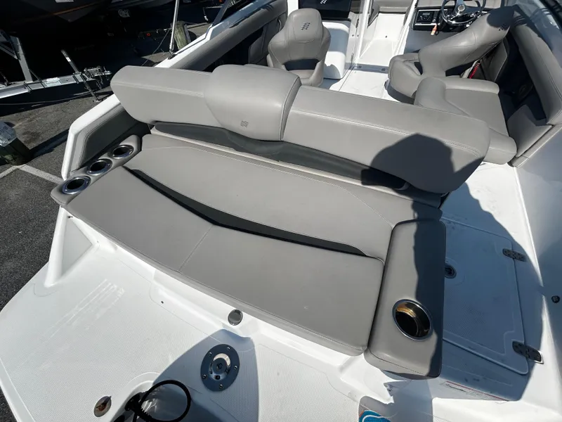 Slide: The Image of 2023 Four Winns HD3 OB boat interior with gray seating and cup holders. - 18