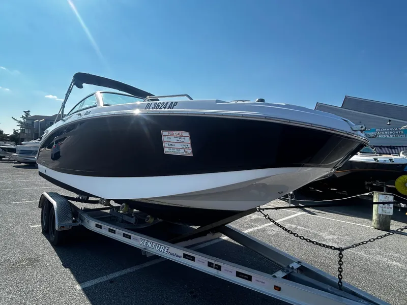 Slide: The Image of 2023 Four Winns HD3 OB boat on trailer in parking lot. - 2