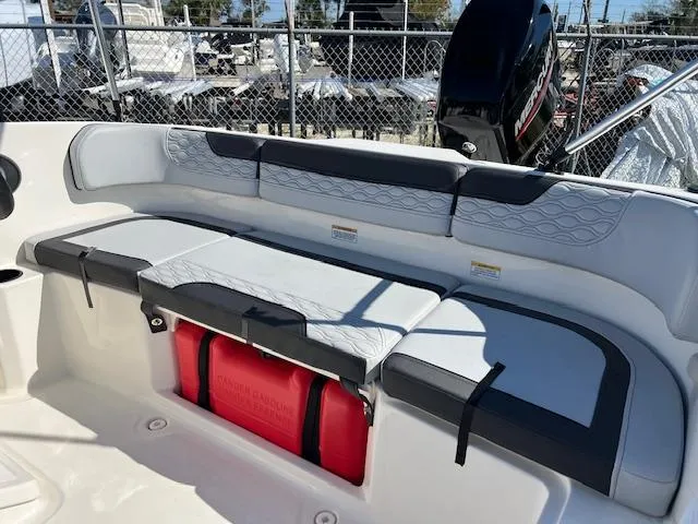 Slide: The Image of 2023 Bayliner Element M15 boat seating with storage compartment, featuring modern design and comfortable cushions. - 2