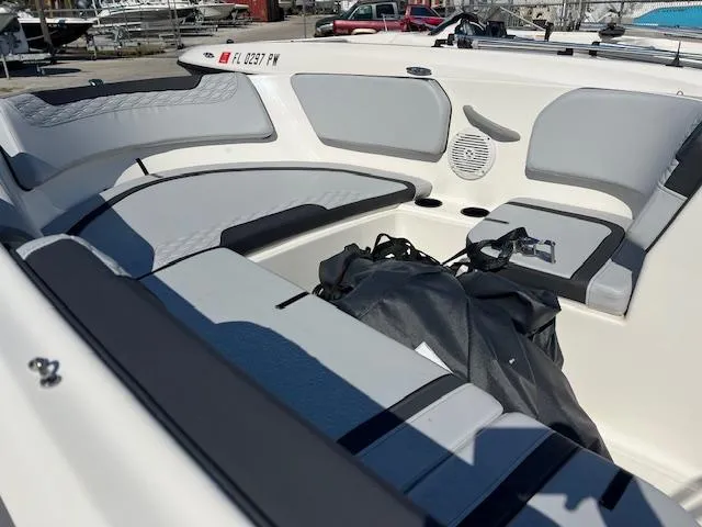 Slide: The Image of 2023 Bayliner Element M15 boat interior with gray seating and storage area. - 5