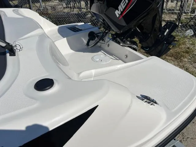 Slide: The Image of 2023 Bayliner Element M15 boat with Mercury outboard motor, white deck, and sleek design. - 7