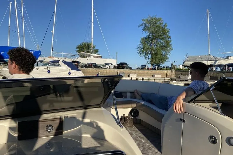 Slide: The Image of 2021 Bennington 27 QXSBWA X2 boat deck with Yamaha engine, beige seating, and clear sky. - 11