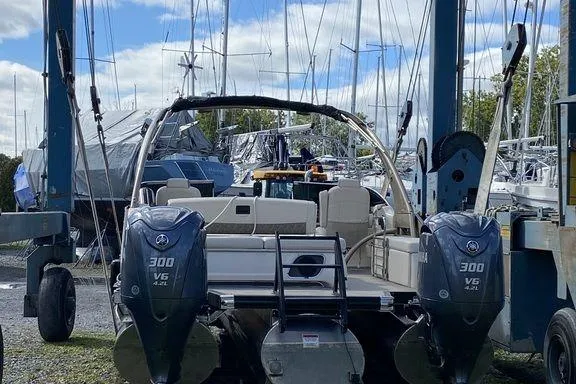 Slide: The Image of 2021 Bennington 27 QXSBWA X2 boat interior with luxurious seating by the water. - 19