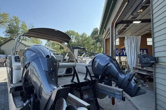 Slide: The Image of 2021 Bennington 27 QXSBWA X2 boat on a lake under a clear blue sky. - 28