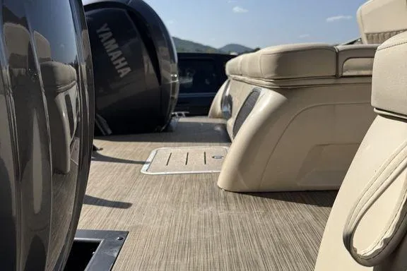 Slide: The Image of Two people relaxing on a 2021 Bennington 27 QXSBWA X2 boat at a marina. - 31