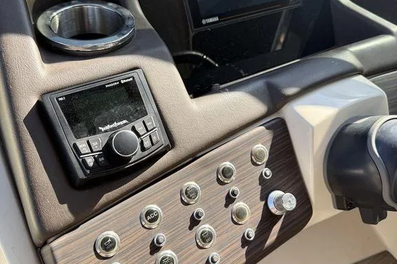 Slide: The Image of 2021 Bennington 27 QXSBWA X2 pontoon boat cruising on a serene lake. - 37