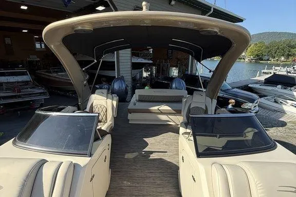 Slide: The Image of 2021 Bennington 27 QXSBWA X2 pontoon boat cruising on a serene lake. - 38