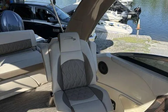 Slide: The Image of People relaxing on a 2021 Bennington 27 QXSBWA X2 boat at a marina. - 42