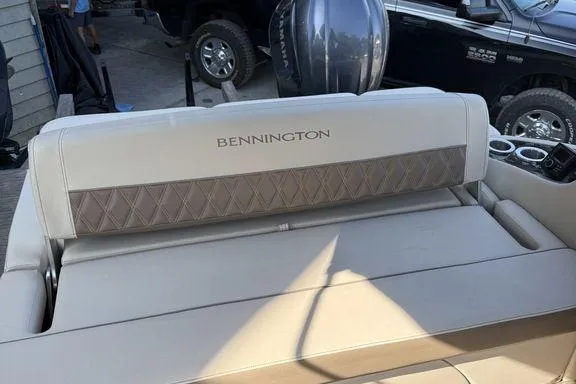 Slide: The Image of 2021 Bennington 27 QXSBWA X2 pontoon boat on a calm lake under a cloudy sky. - 44