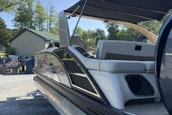 Slide: The Image of 2021 Bennington 27 QXSBWA X2 pontoon boat on calm water, clear sky. - 47