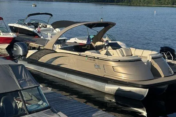 Slide: The Image of 2021 Bennington 27 QXSBWA X2 pontoon boat with Yamaha engine, under clear blue sky. - 5