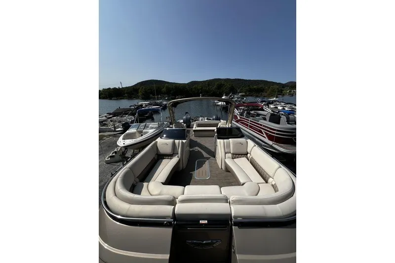 Slide: The Image of 2021 Bennington 27 QXSBWA X2 pontoon boat with spacious seating at a marina. - 51