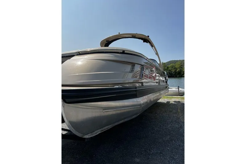 Slide: The Image of 2021 Bennington 27 QXSBWA X2 pontoon boat by the water on a sunny day. - 53