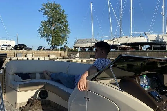 Slide: The Image of 2021 Bennington 27 QXSBWA X2 pontoon boat docked in a sunny marina. - 6