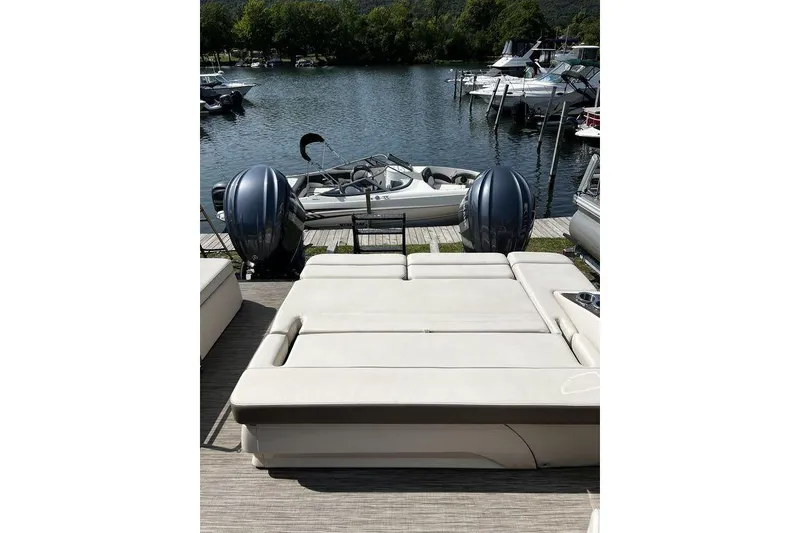 Slide: The Image of 2021 Bennington 27 QXSBWA X2 pontoon boat with dual engines docked by a scenic lake. - 63