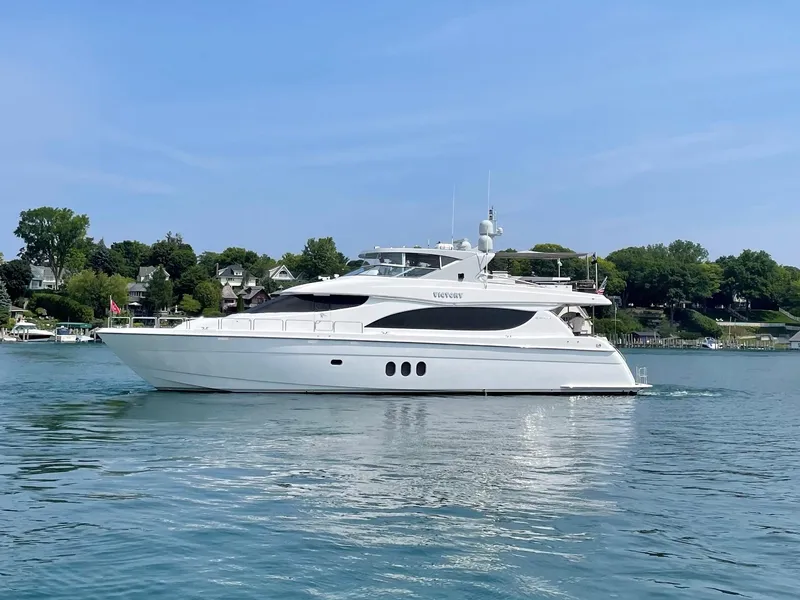 Slide: The Image of 2008 Hatteras 80 Motor Yacht cruising on a calm lake with scenic shoreline. - 0