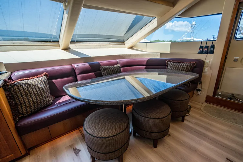 Slide: The Image of Luxurious interior of 2008 Hatteras 80 Motor Yacht with plush seating and elegant table. - 10