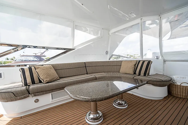 Slide: The Image of Luxurious seating area on 2008 Hatteras 80 Motor Yacht with elegant table and cushions. - 25