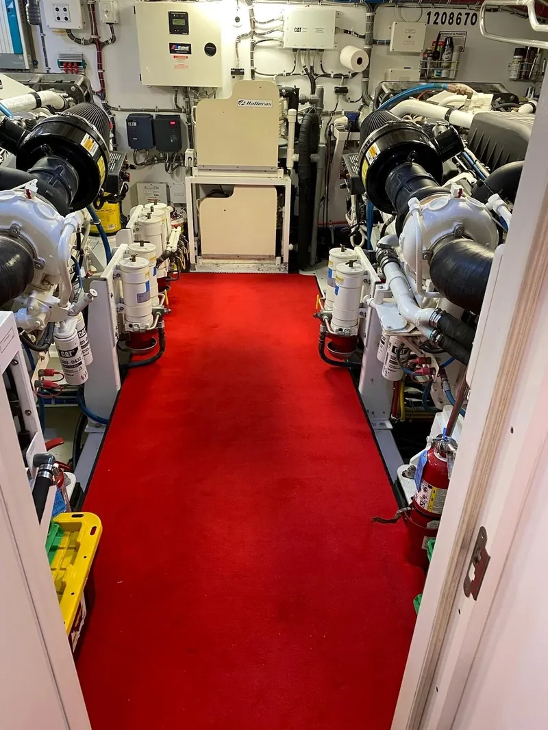 Slide: The Image of Engine room of 2008 Hatteras 80 Motor Yacht with red carpet and machinery. - 32