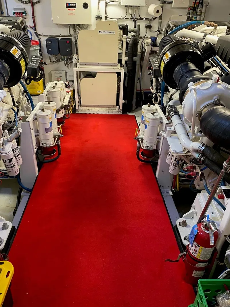 Slide: The Image of Engine room of 2008 Hatteras 80 Motor Yacht with red carpet and machinery. - 33