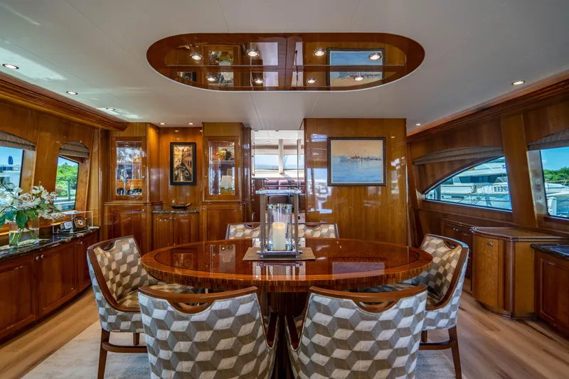 Slide: The Image of Luxurious dining area in 2008 Hatteras 80 Motor Yacht with elegant wood finishes. - 5