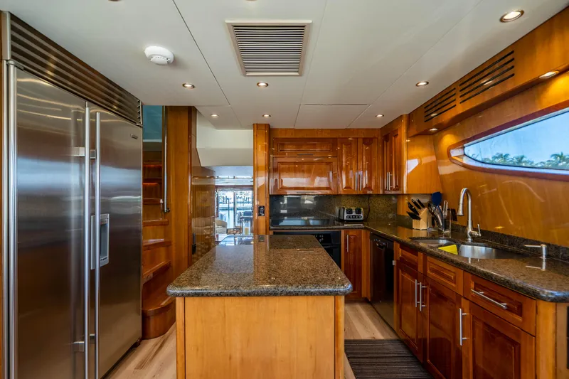 Slide: The Image of Luxurious kitchen interior of 2008 Hatteras 80 Motor Yacht with modern appliances and wood cabinetry. - 8