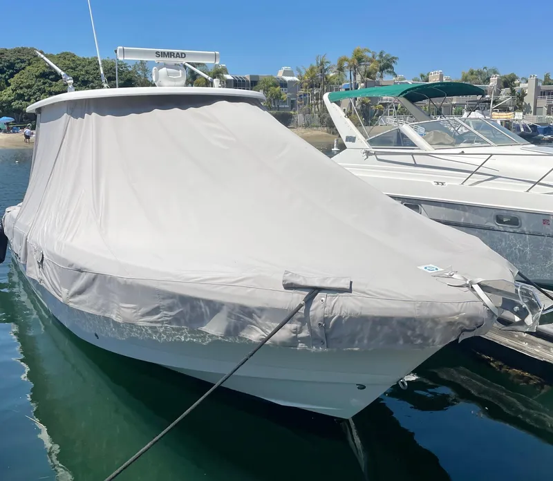 Slide: The Image of 2017 Robalo R302 Center Console boat covered at dock. - 35