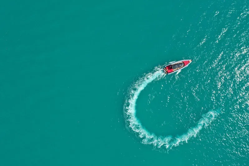 Slide: The Image of Aerial view of 2021 Panamera Yacht PY 100 making a turn in turquoise water. - 5