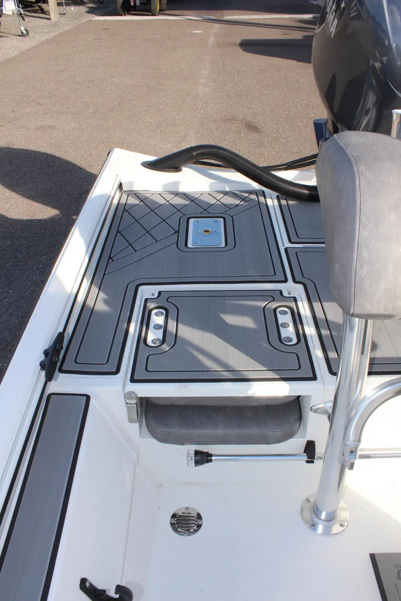 Slide: The Image of Avid 20 Rogue CC 2026 boat interior with storage compartment and metal fixtures. - 12