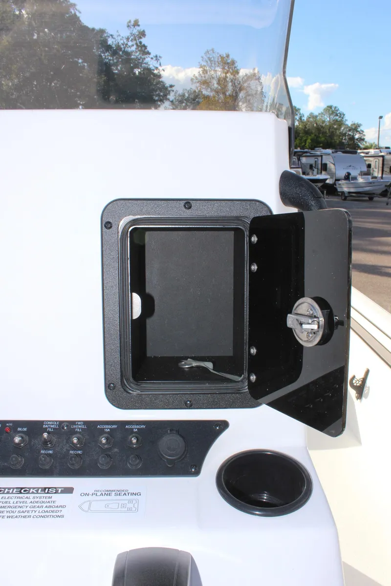 Slide: The Image of 2026 Avid 20 Rogue CC boat interior with storage compartments, parked on a trailer. - 17