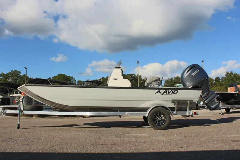 The Image of 2026 Avid 20 Rogue CC boat on trailer, side view, parked outdoors. - 2