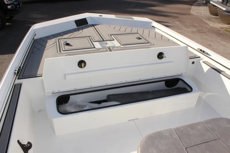 Slide: The Image of 2026 Avid 20 Rogue CC boat interior with seating and console, displayed at a dealership. - 22
