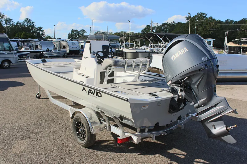Slide: The Image of 2026 Avid 20 Rogue CC boat on trailer, rear view, parked outdoors. - 8