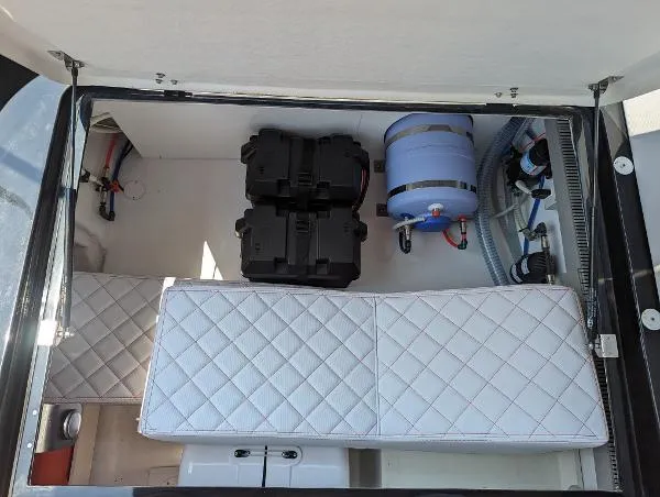 Slide: The Image of Interior view of 2021 Panamera Yacht PY 100 storage compartment with quilted seating and equipment. - 13