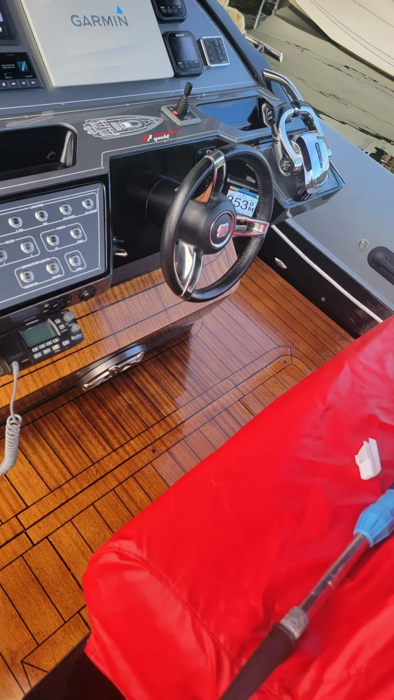 Slide: The Image of Panamera Yacht PY 100 cockpit with Garmin navigation, 2021 model, featuring sleek wood finish. - 4