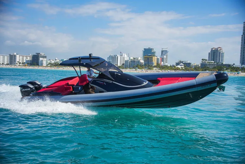 The Image of 2021 Panamera Yacht PY 100 cruising on clear blue water near city skyline. - 0